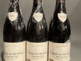 three bottles of wine sitting on top of a table next to each other