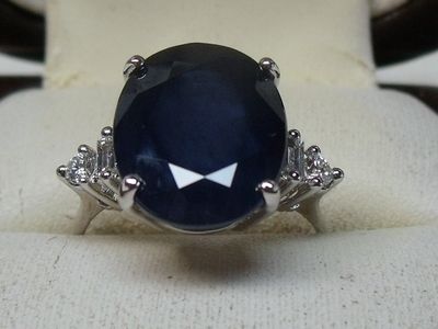 an image of a ring with a blue stone on it