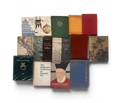 several books are stacked on top of each other on a white surface