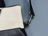 a black and white purse with a black and white strap