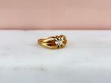 an image of a gold ring sitting on a marble surface