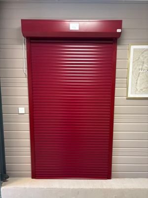 a red roller up door in a storage unit
