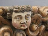 a close up of a carved head of a child