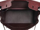 the inside of a brown and black purse with a handle