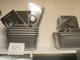 many pans and pans on the shelves in the kitchen