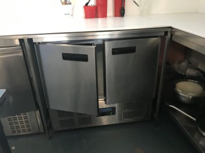 a stainless steel counter top with two ovens in it
