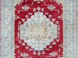 a red rug with a medallion design on it