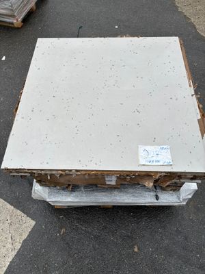 a stack of boxes on the ground next to a pallet