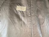 an image of a brown leather jacket on a mannequin