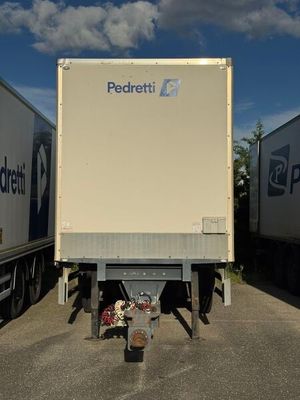 two semi trucks that are parked in a parking lot