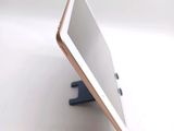a tablet computer sitting on a stand on a table