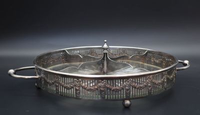 silver plated serving dish with handles and handles on a black surface