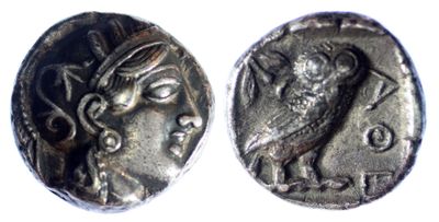 a close up of a coin with an owl on it