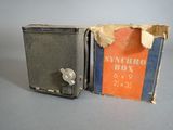 an old box with a key on it sitting next to another box