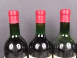 three bottles of wine that are sitting on a table