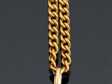 an image of a gold and silver necklace with a cross on it