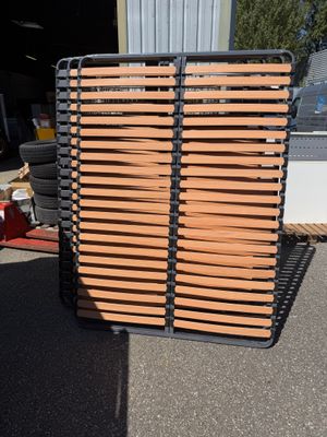 wooden slats stacked on top of each other in front of a building