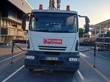 a truck that is driving down the street in front of a building