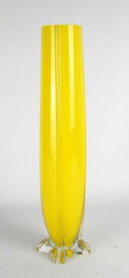 yellow glass vase with feet on a white background