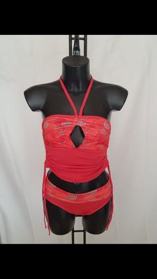 a close up of a mannequin wearing a red dress on a mannequin stand