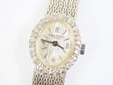 an image of a woman ' s wrist watch with a diamond bezeled dial