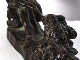 a statue of a man and a dog sitting on a log