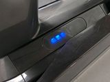 a close up of a blue light on the side of a machine