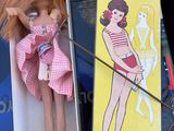 a doll in a box with a stick in it