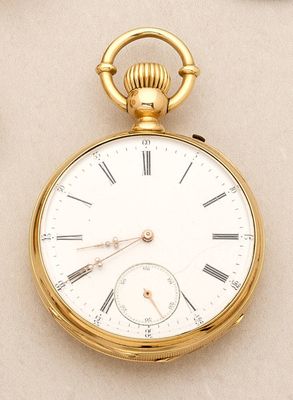 a gold pocket watch with roman numerals on it