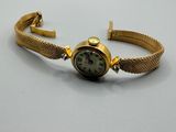 l'image d'une montre-bracelet en or entourée d'une chaîne