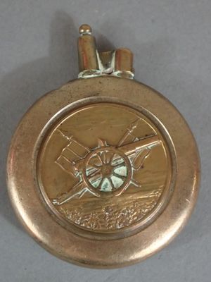 a gold medal with a picture of a man holding a baseball bat