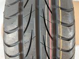 a close up of a car tire with a red stripe on it