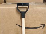 boxes with amazon boxes and a wooden handle with a smile drawn on it