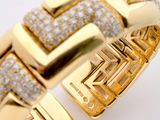 an image of a gold bracelet with diamonds on a white background