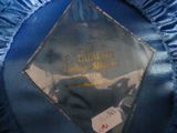 a close up of a blue satin jacket with a label on it