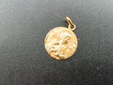a close up of a gold coin on a black surface