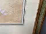 framed picture of a painting of a purple flower in a gold frame