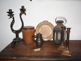 a wooden table topped with antique items on top of it