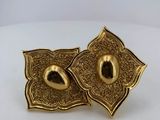 a pair of gold tone earrings with a flower design