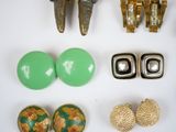 many different pieces of jewelry on a white surface