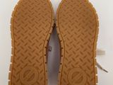 the soles of a pair of brown shoes on a white surface