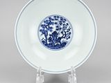 a blue and white plate with a landscape scene on it