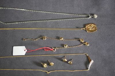 a lot of gold necklaces on a table