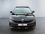 the front view of a black car in a white room