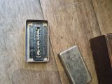 a small box with a razor and a lighter on a table