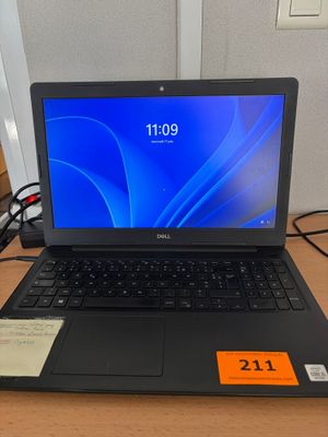 a laptop that is sitting on a desk with a price tag on it