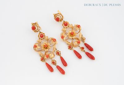 pair of red and gold earrings on a white surface