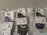 several pairs of socks are wrapped in plastic bags on a table