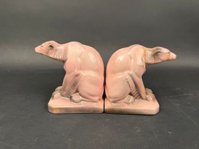 pair of pink ceramic figurines of a cat and a dog