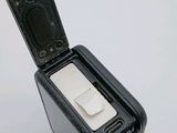 a small black box with a white button on it